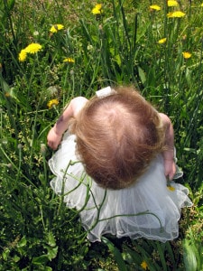 child in field flowers