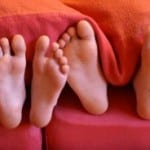 feet-out-from-under blanket-image