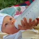 newborn_drinking_milk_outdoors_image