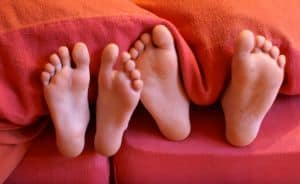 little-feet-under-blanket-image